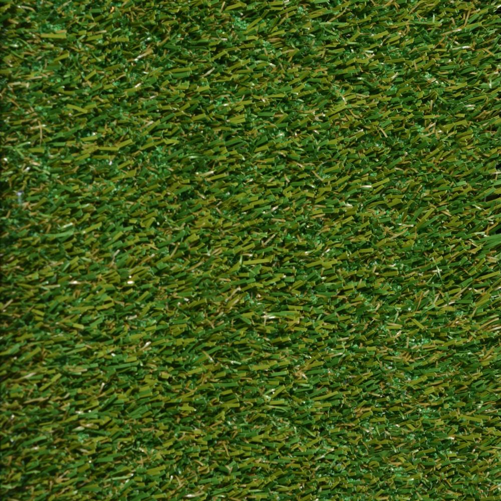 Close up shot of pet turf with green and brown grass strands Close up shot of pet turf with green and brown grass strands