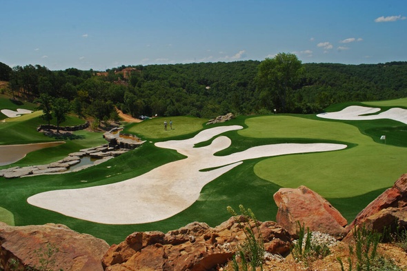 Phoenix lush green synthetic grass golf course with white sand bunkers and blue sky