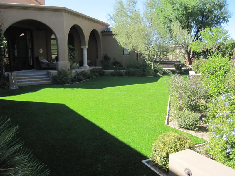 artificial turf in a front yard with a house