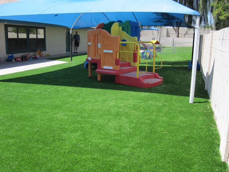 artificial turf in a front yard with a child playset