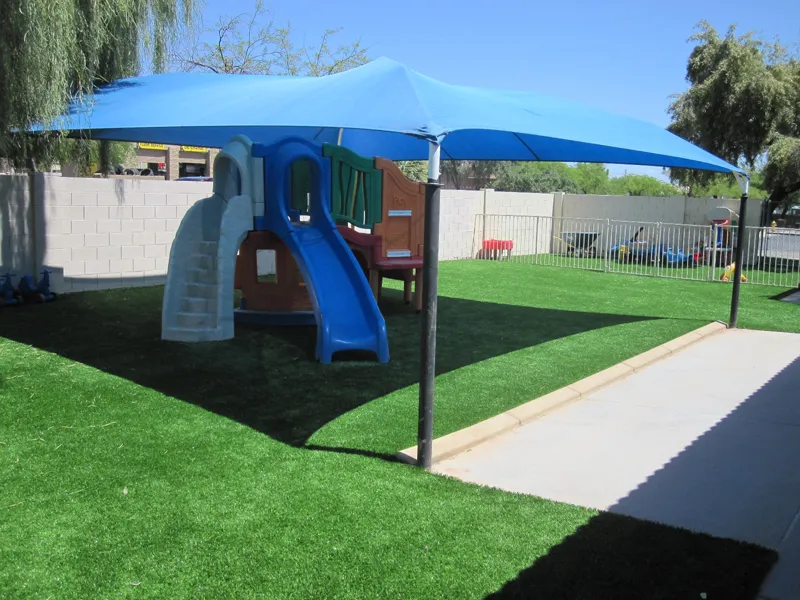 artificial turf in a front yard with a child playset