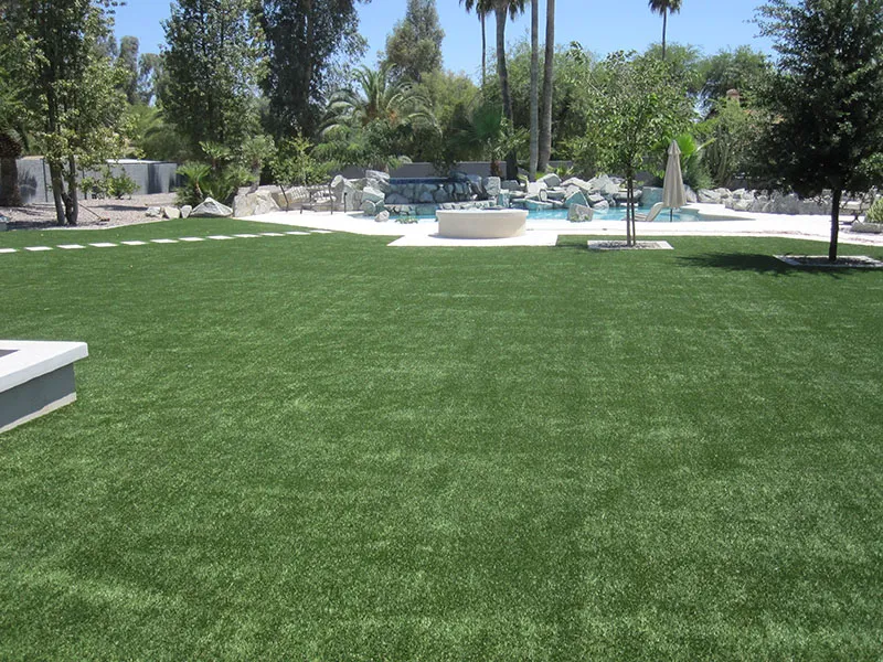 artificial turf in a front yard with a pool