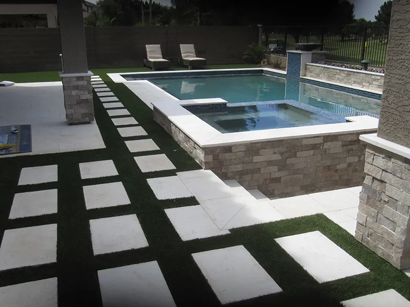artificial turf in a backyard with a pool