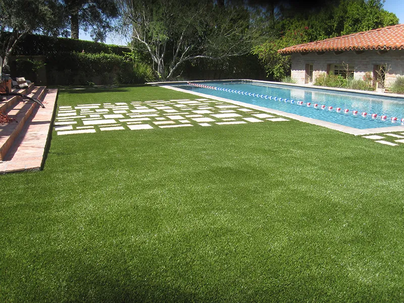 artificial turf in a backyard near a pool