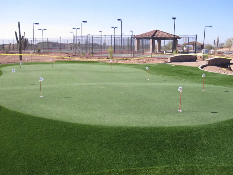 a putting green near tennis courts