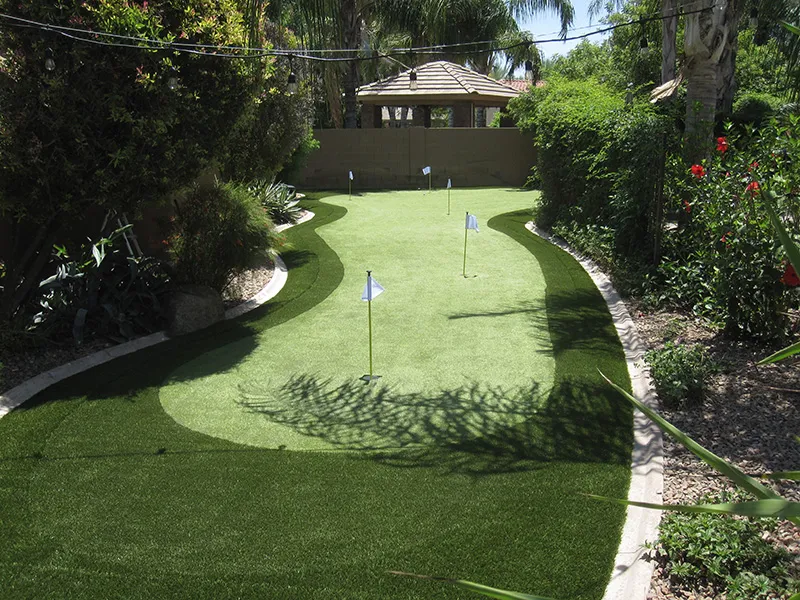 a putting green in a narrow space in a backyard