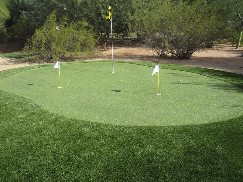 a putting green with 3 hole flags