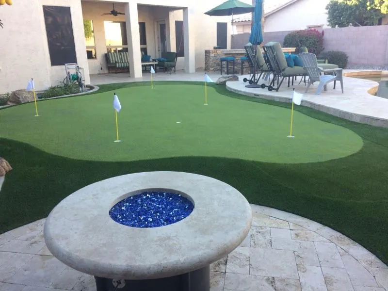 a backyard putting green set against a house
